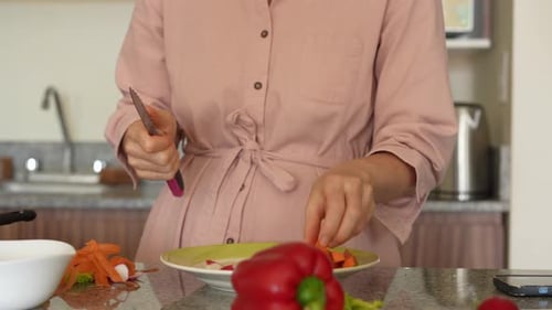 Woman Prepares Vegetables in Kitchen