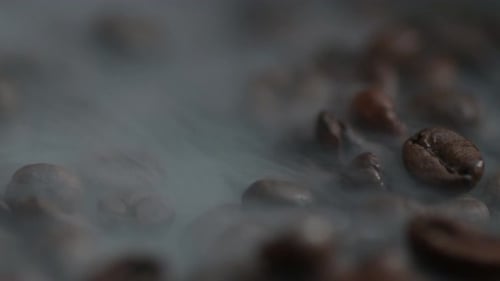 Roasted Coffee Beans with Vaporous Smoke Macro Shot