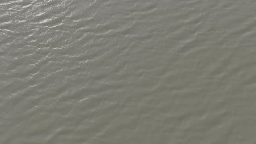 Water Surface With a Small Wave Waves on the Pond Surface Waves in Shallow Water Aerial View Flying
