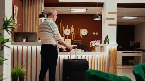 Hotel Lobby: Man Checking in with Receptionist