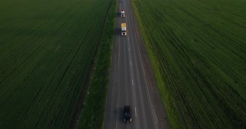 Aerial Shot Trucks and Cars Driving on the Road During Sunset