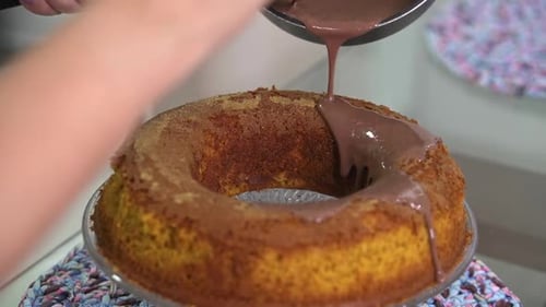 Pouring Chocolate Frosting on Cake Dessert