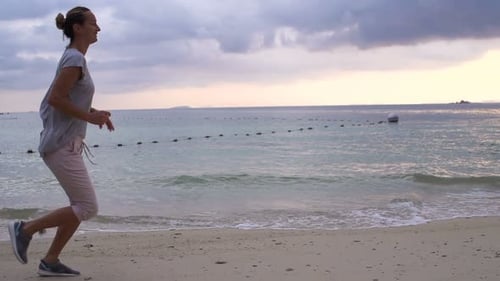 Young Woman Jogging on Beach During Sunset, Super 240
