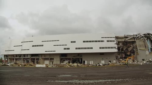 Machines and People Work at Ruined Hockey Stadium Timelapse