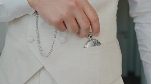 Man Puts Pocket Watch Into Vest Pocket