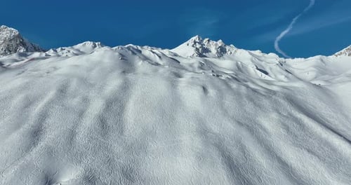 Majestic Snowy Mountains Under Blue Sky Aerial Shot