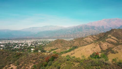 Aerial drone flying over a blue water lake with mountains landscape