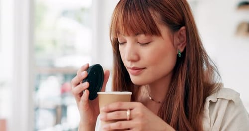 Face, smile and asian woman smelling coffee in cafe for fresh aroma with caffeine beverage to relax