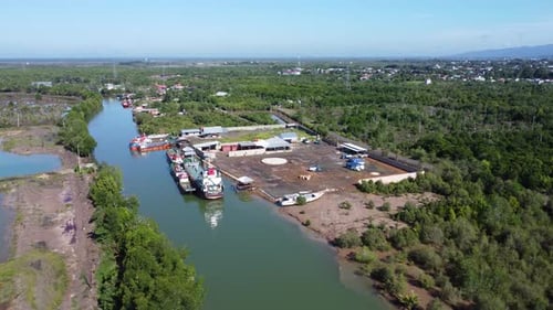 Aerial view of tankers carrying palm oil docked at a small pier to supply it to palm oil distributor
