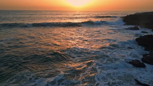 Stormy Sea Breaking Cliffs at Sunset Drone View Ocean Waves Crashing Stones
