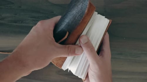 Opening vintage leather notebook point of view