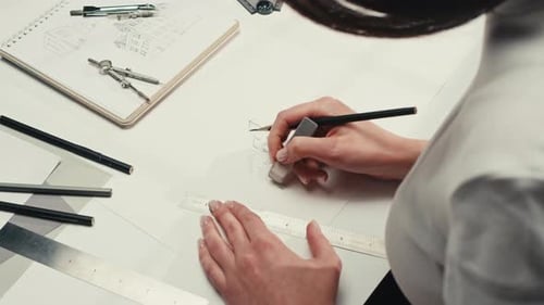Young Woman Artist is Drawing Buildings By Pencil Using Ruler on White Paper The Designer or