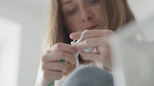 The Knitter Maker Makes Knitted Products in Her Workshop Needlewoman with Skillful Hands Unweaves