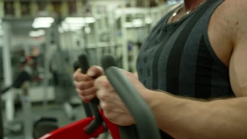 Adult Man Working Out on Rowing Machine