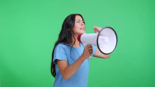 Angry Woman Shouting on a Megaphone Against a Green Screen