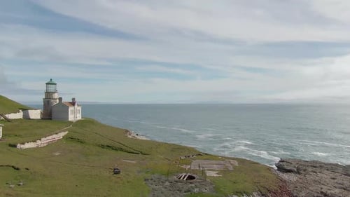 Historic lighthouse on the Pacific coast (low orbit aerial).