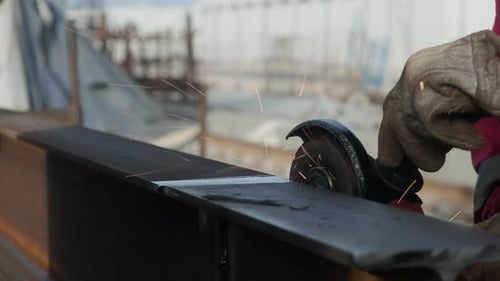 Worker Grinds Metal