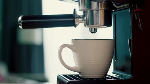 Pouring Coffee Stream From Machine in Cup Home Making Hot Espresso Using Filter Holder Flowing Fresh
