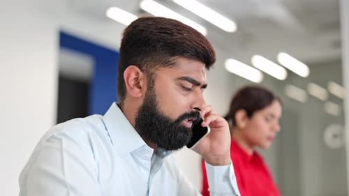 Professional Man Talking on Cell Phone in Office
