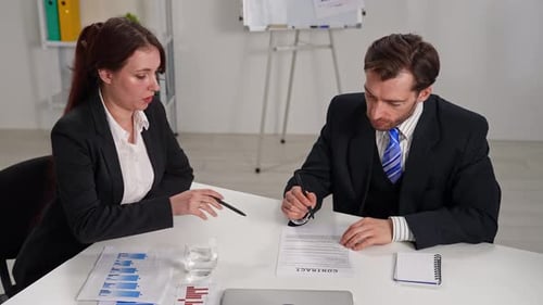Business Meeting with Two People in Office Setting
