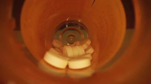 White Pills Poured Into Blue Medicine Bottle Cap