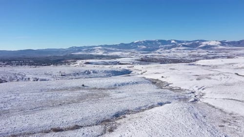 Aerial View of Snow Covered Hills and Mountain in the Winter