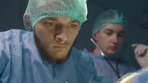 Close Up Portrait of Super Concentrated Male Veterinarian During Vet Surgery