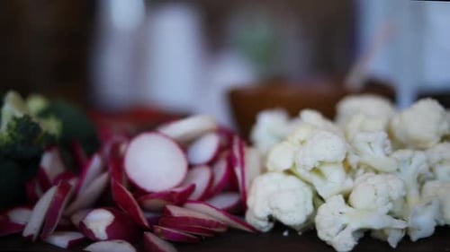 A slow Panning Shot over a platter of vegetables including broccoli, cauliflower, mushrooms, carrots