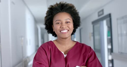Smiling Medical Professional in Hospital Hallway Portrait