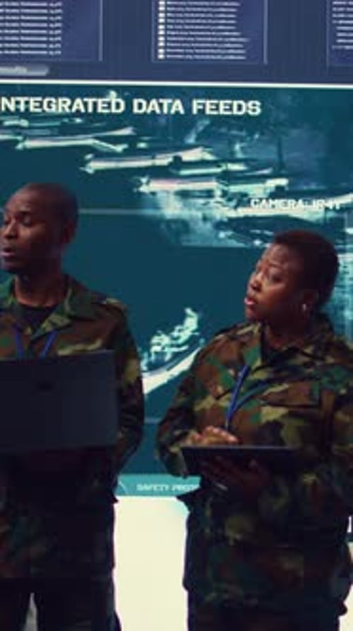 Vertical Video Sergeant Major and Female Soldier Checking Real Time Field Data in Command Post