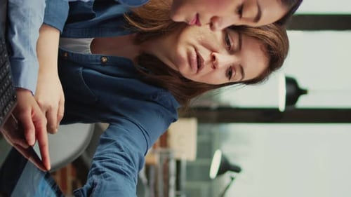 Women Collaborating on Design Tablet in Modern Office