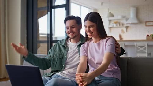 Couple Video Chatting on Laptop at Home
