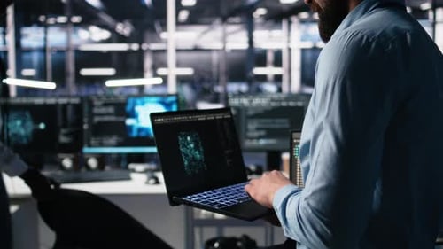 Close Up of Developer in Data Center Coding with Generative AI on Laptop