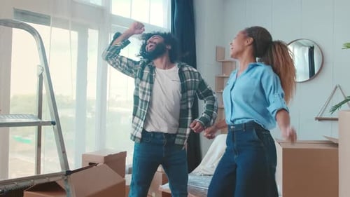 Happy Couple Dancing in New Apartment After Moving