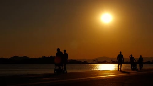 People Watching Sunset on Ocean Path