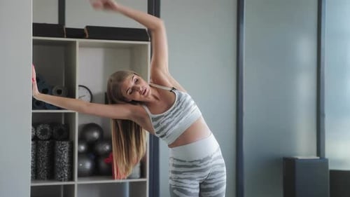 Prenatal Yoga Instructor Demonstrating Side Stretch for Expectant Mothers