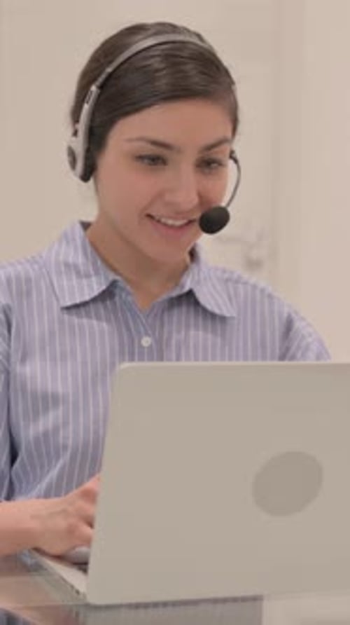 Indian Woman with Headset Talking with Customers Online in Call Center, vertical