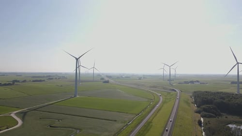 Aerial view of wind turbines along highway