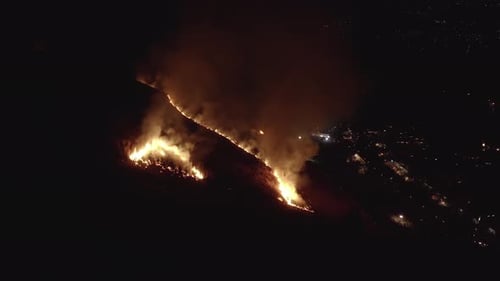 Fire blazes on mountainside of Wakakusa, Nara Japan. Aerial Pan at Night