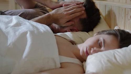 Affectionate Couple Waking in Bed With Kiss