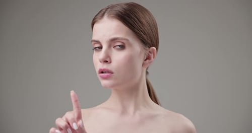 Woman Pointing Finger Elegantly in Studio Close-up