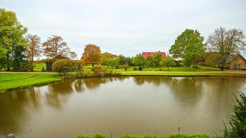 Twilight time lapse of beautiful sunrise over natural lake in park during cloudy day with flying clo