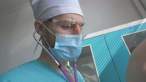 Doctor Listening to Patient's Heart with Stethoscope