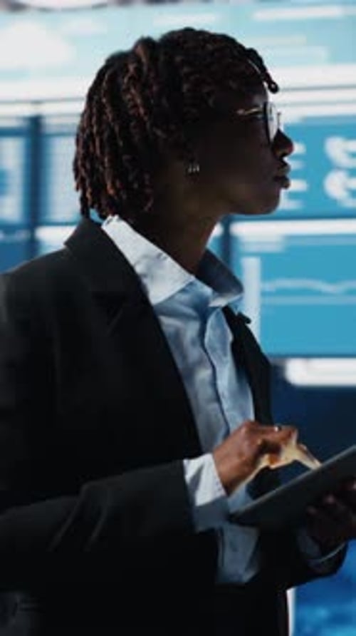 Vertical Video Business Specialist Using Tablet to Review Performance Dashboards Metrics