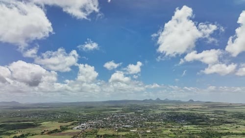 An aerial view of a rural area with clouds in the sky