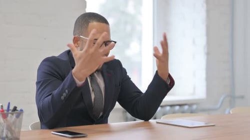 Man Talking at Desk, Expressing Conflict