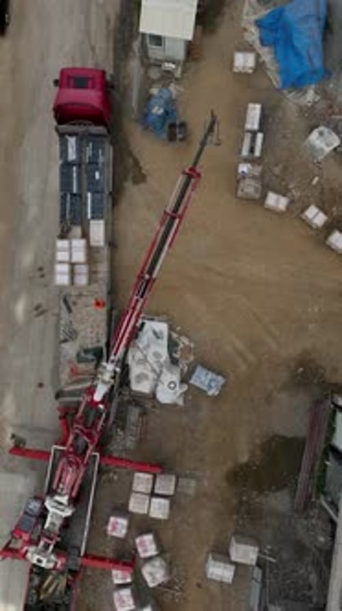 Vertical Video Building Progress Aerial View of Construction Site with Crane and Working Crew