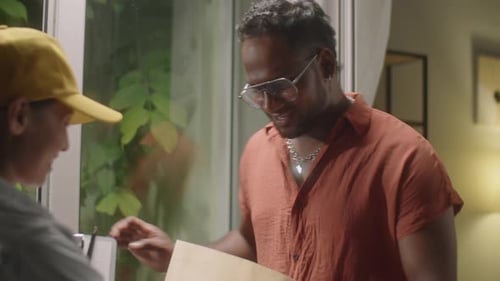 Delivery Woman Hands Package to Stylish Man