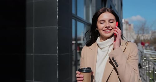 Woman Goes Near the Office Building and Talking on the Phone