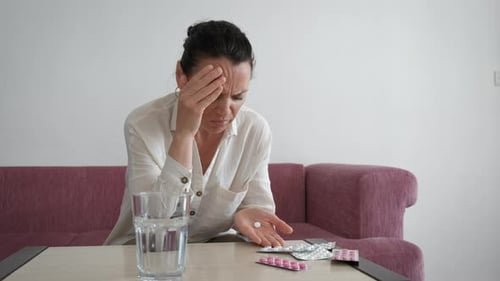 Young Lady Taking Medication Indoor